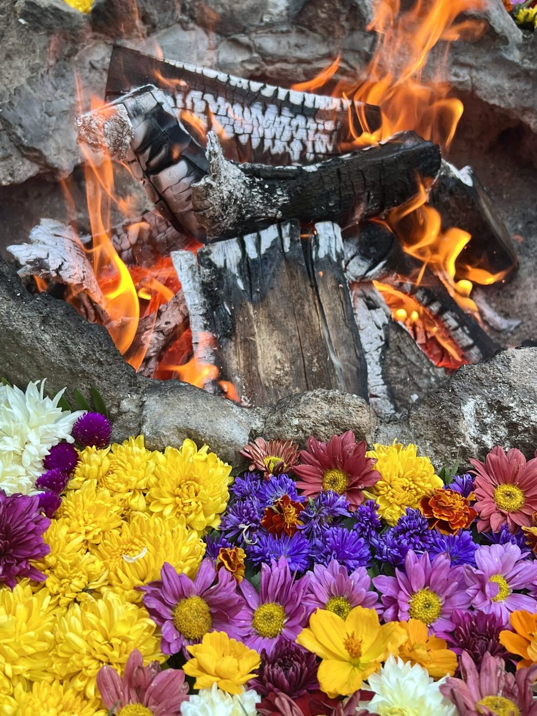 A Maya ceremonial fire ringed with flowers at Lake Atitlán